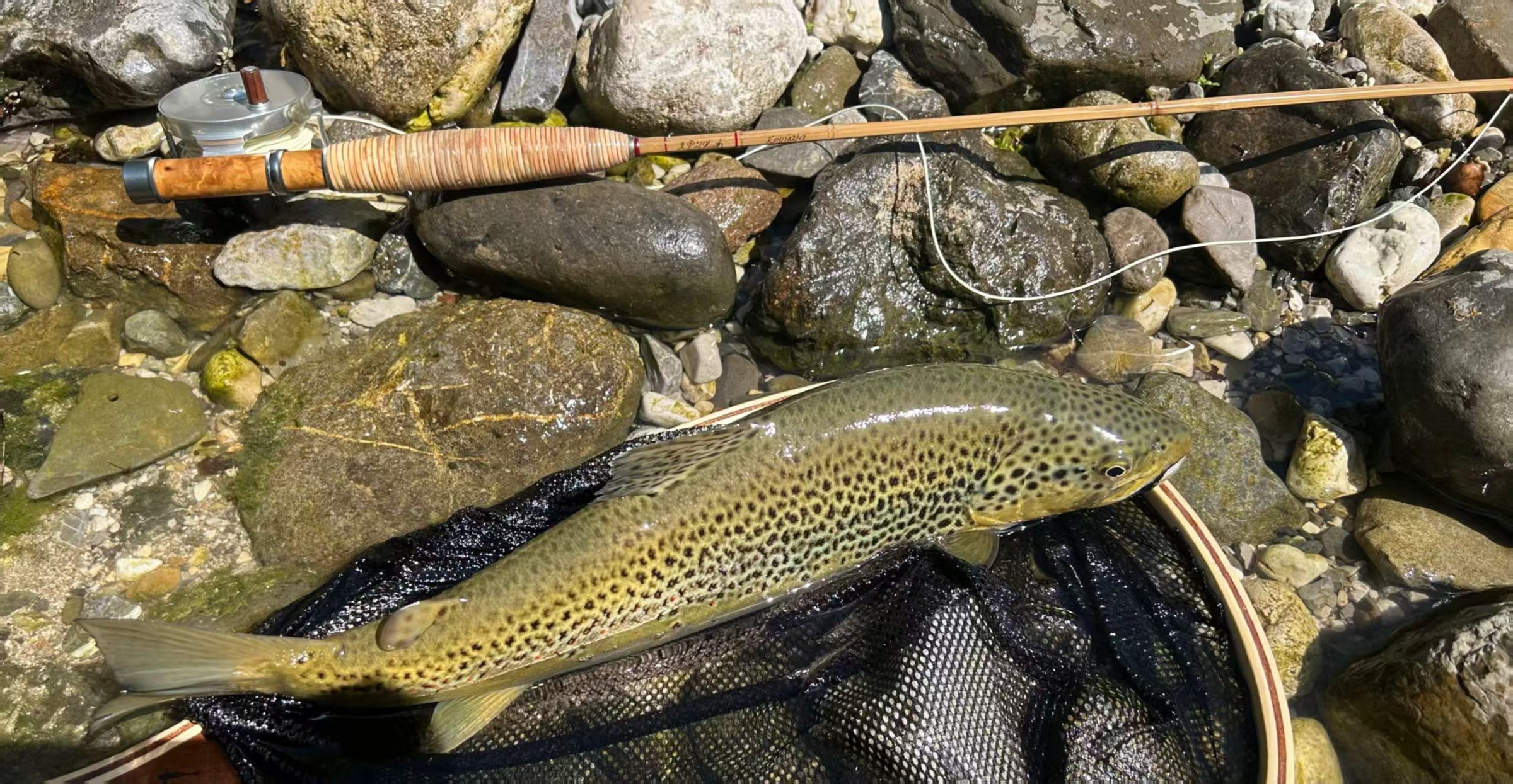 A ZHUSROD bamboo fly rod with cork grip, reel seat and rod case