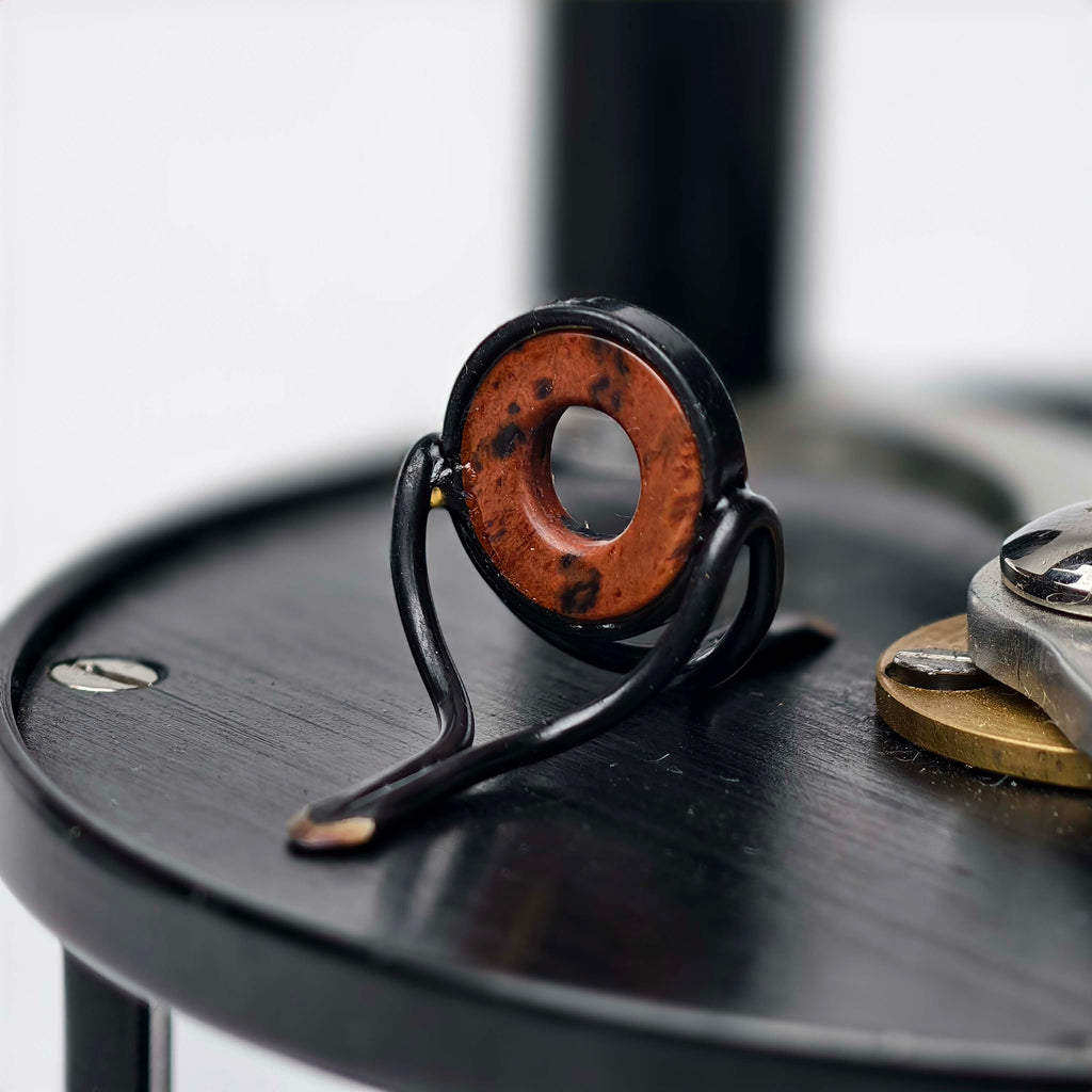 ZHUSROD dark agate fly rod stripping guide with black nickel silver frame, angled detail on fly reel